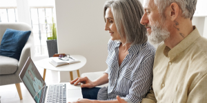 An older couple sitting on a telehealth call with their doctor.